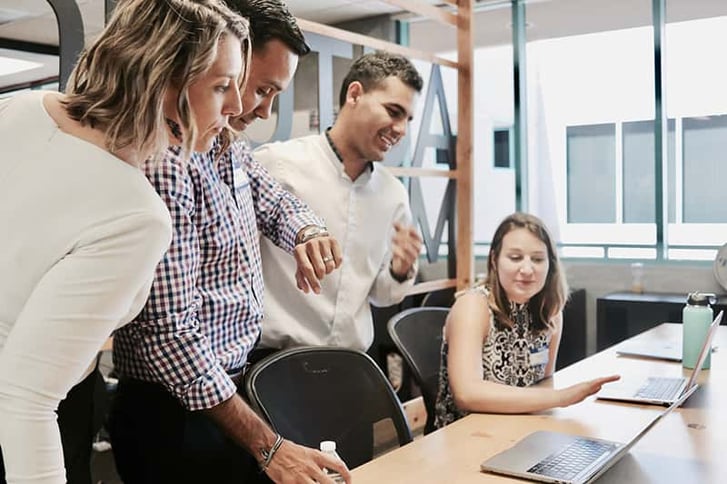 Group of employees looking at screen Group of employees looking at screen